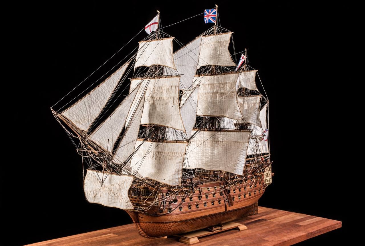 Completed model of HMS Victory under full sail, photographed against black