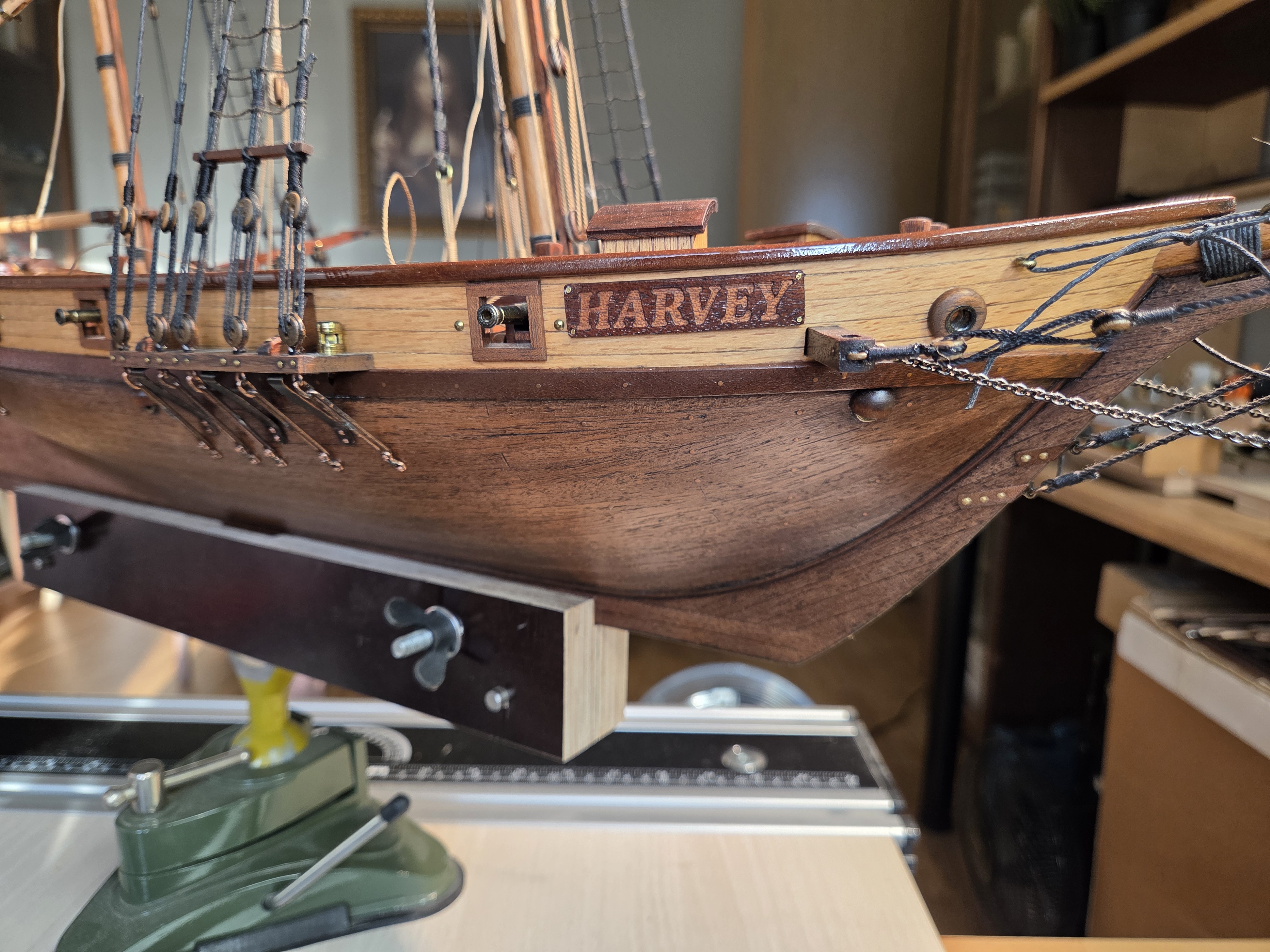 The Harvey's hull on the building board, with deadeyes and shrouds set up along the channel