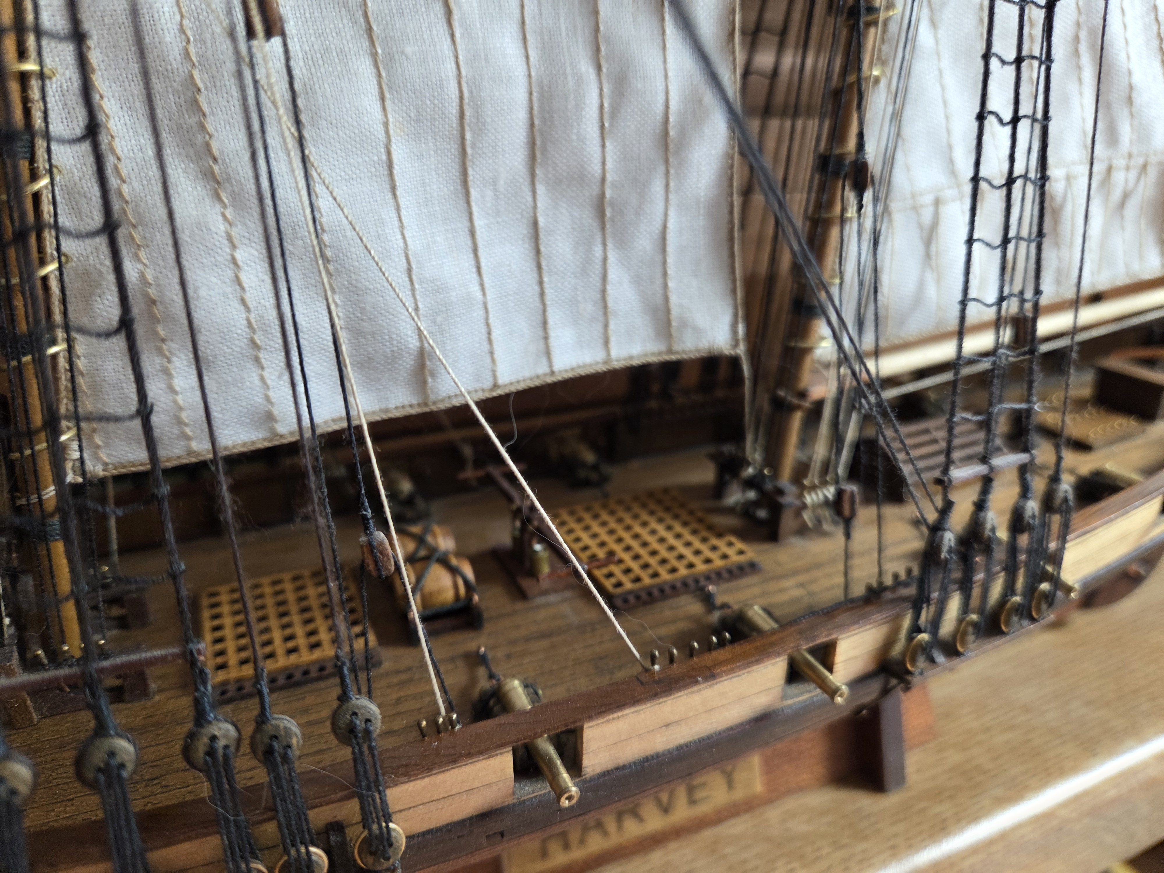 Set sails and running rigging above the deck gratings of the Harvey