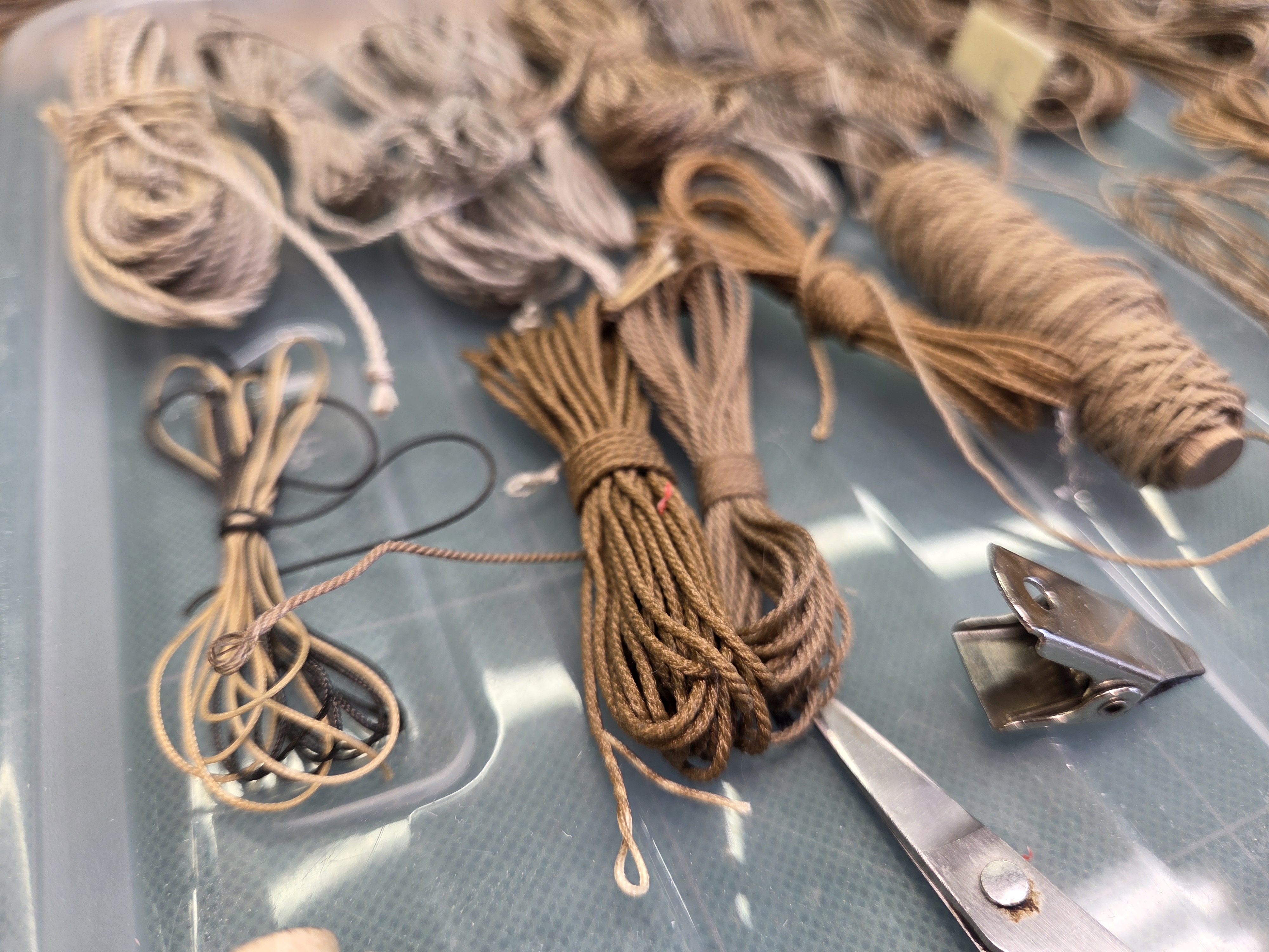 Close view of finished rope hanks beside the tools used to cut them